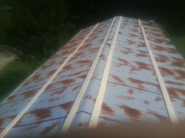 Rusted metal roof panels with new wood purlins before replacement — Storm Damage Roof Repair in Frazeysburg by Roofing Brothers