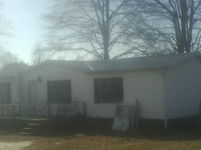 New metal roof on a white painted brick home on a foggy morning in Frazeysburg