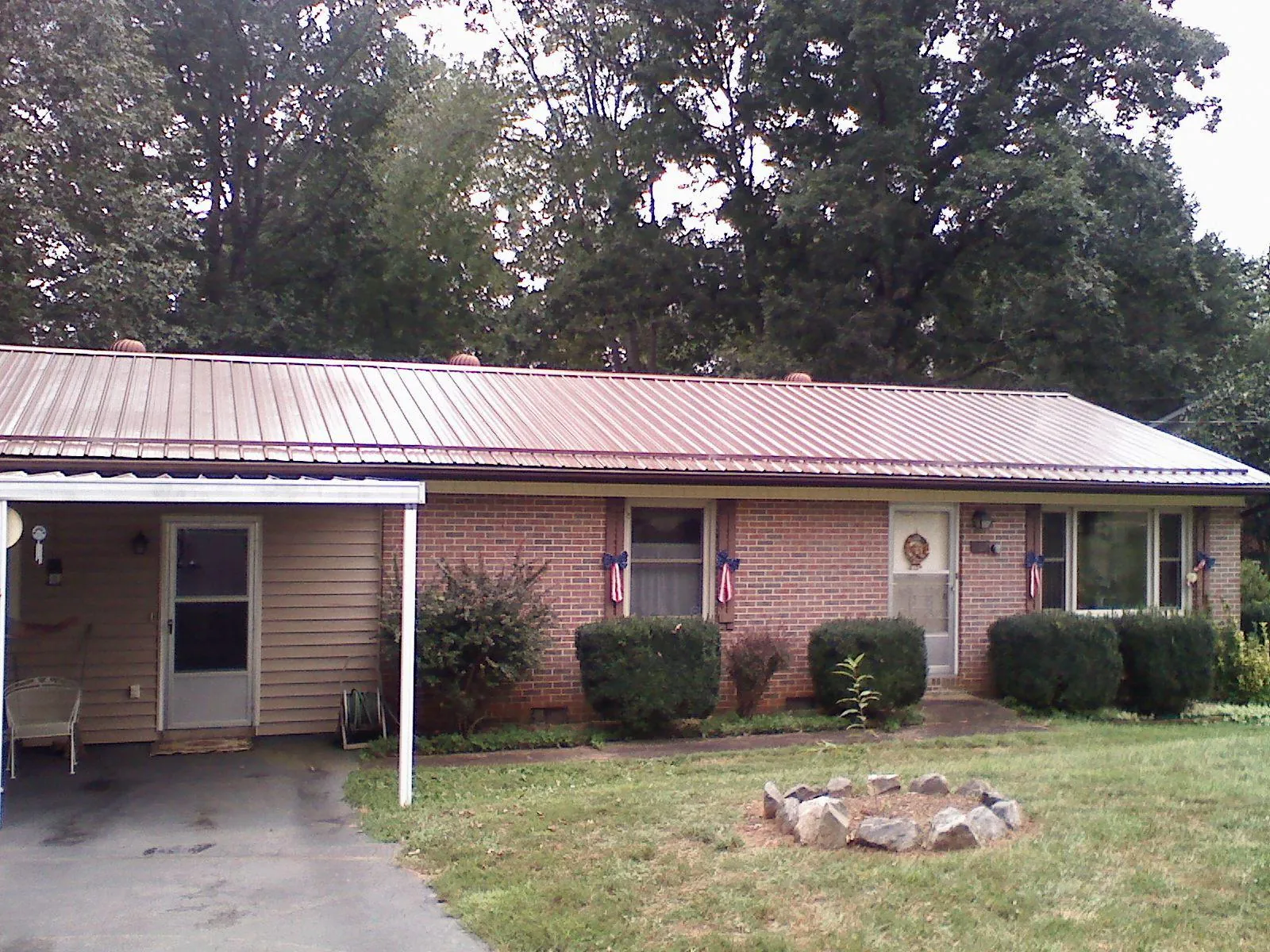 Bronze metal roof and carport on a brick ranch home — Roof Repair work by our crew in Frazeysburg