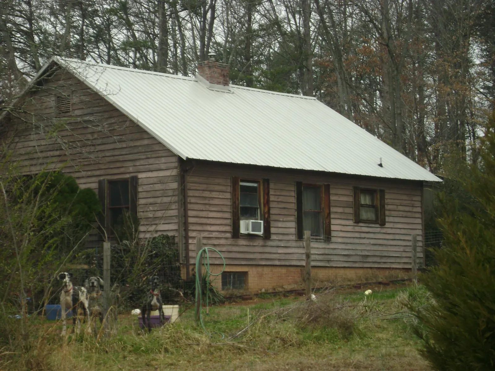 White metal roof on an old wood sided farmhouse, from a Metal Roof Installation job in Frazeysburg